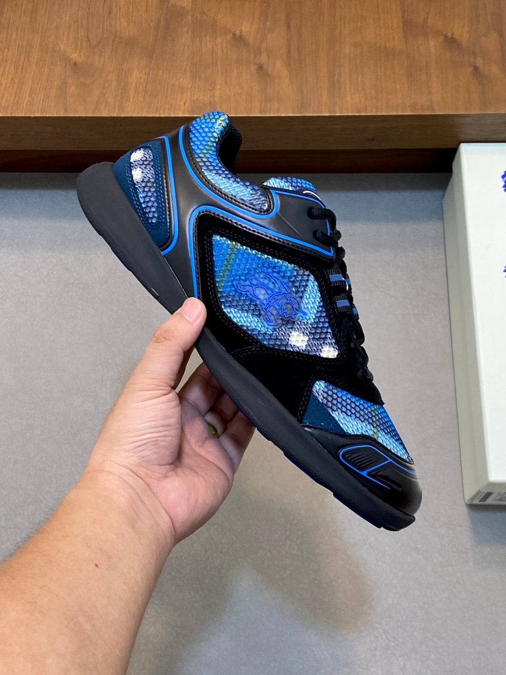 Handheld blue and black lace-up sneaker with textured upper and thick sole, Burberry