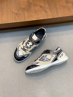 Pair of low-top sneakers, beige and navy patterned panels, black outsole edge, lace-up