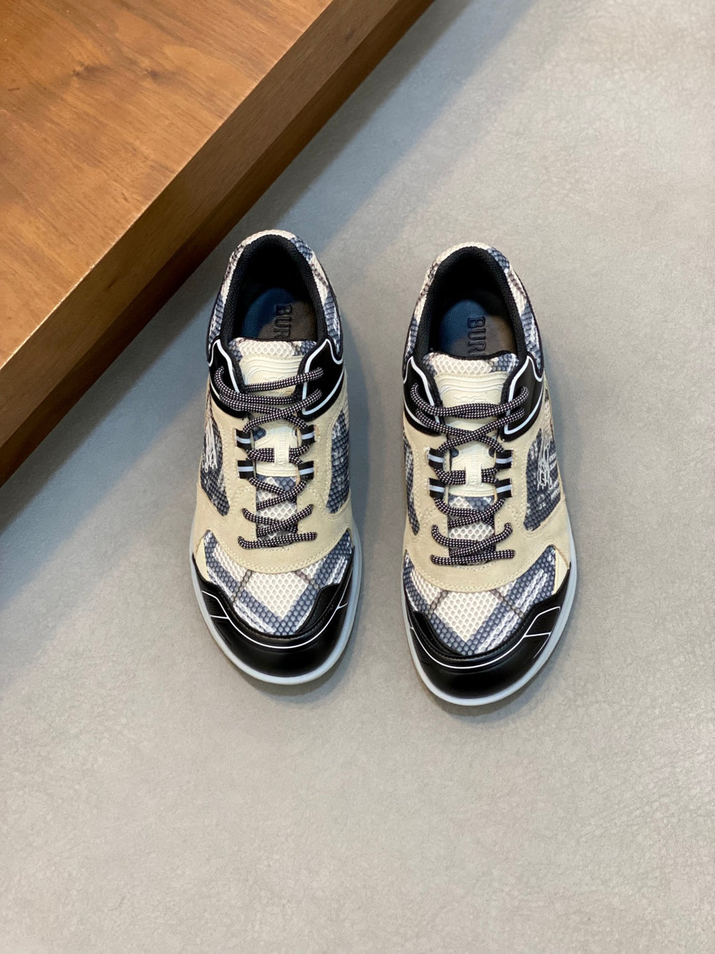 Low-top lace-up sneakers in beige and navy, patterned panels and black trim