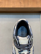 Inside collar of low-top lace-up sneaker with Burberry text in navy