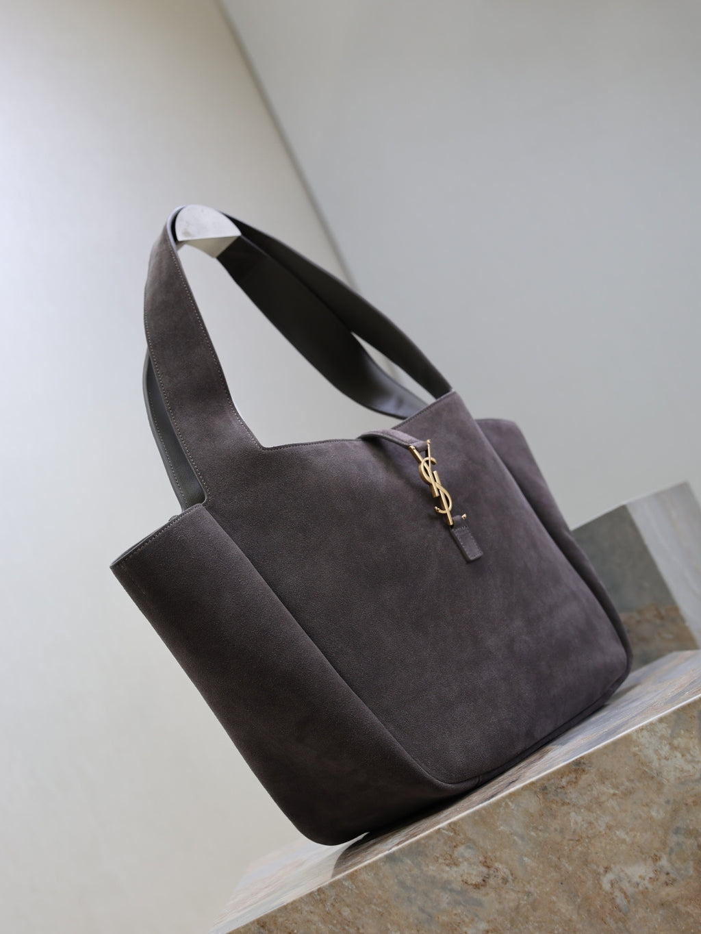 Dark gray suede tote bag with short handles and front YSL logo charm