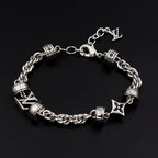 Louis Vuitton charm bracelet closeup, silver linked chain with logo blocks and star charms