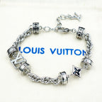 Silver chain bracelet with barrel charms and star pendant details