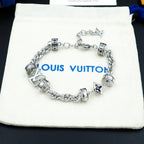 Louis Vuitton charm bracelet on pouch, silver linked chain with logo beads and star charm