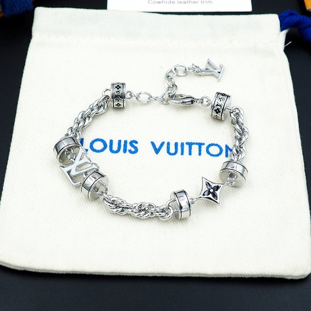 Louis Vuitton charm bracelet on pouch, silver linked chain with logo beads and star charm