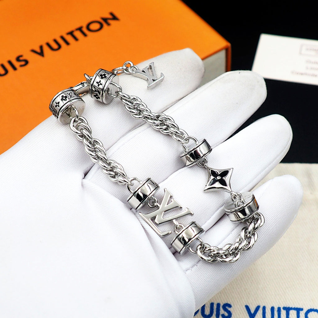 Louis Vuitton charm bracelet on glove, silver linked chain with logo beads and star charm