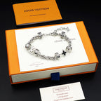 Louis Vuitton charm bracelet, silver linked chain with logo beads and star charm