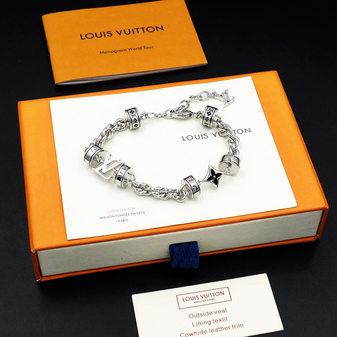 Louis Vuitton charm bracelet, silver linked chain with logo beads and star charm