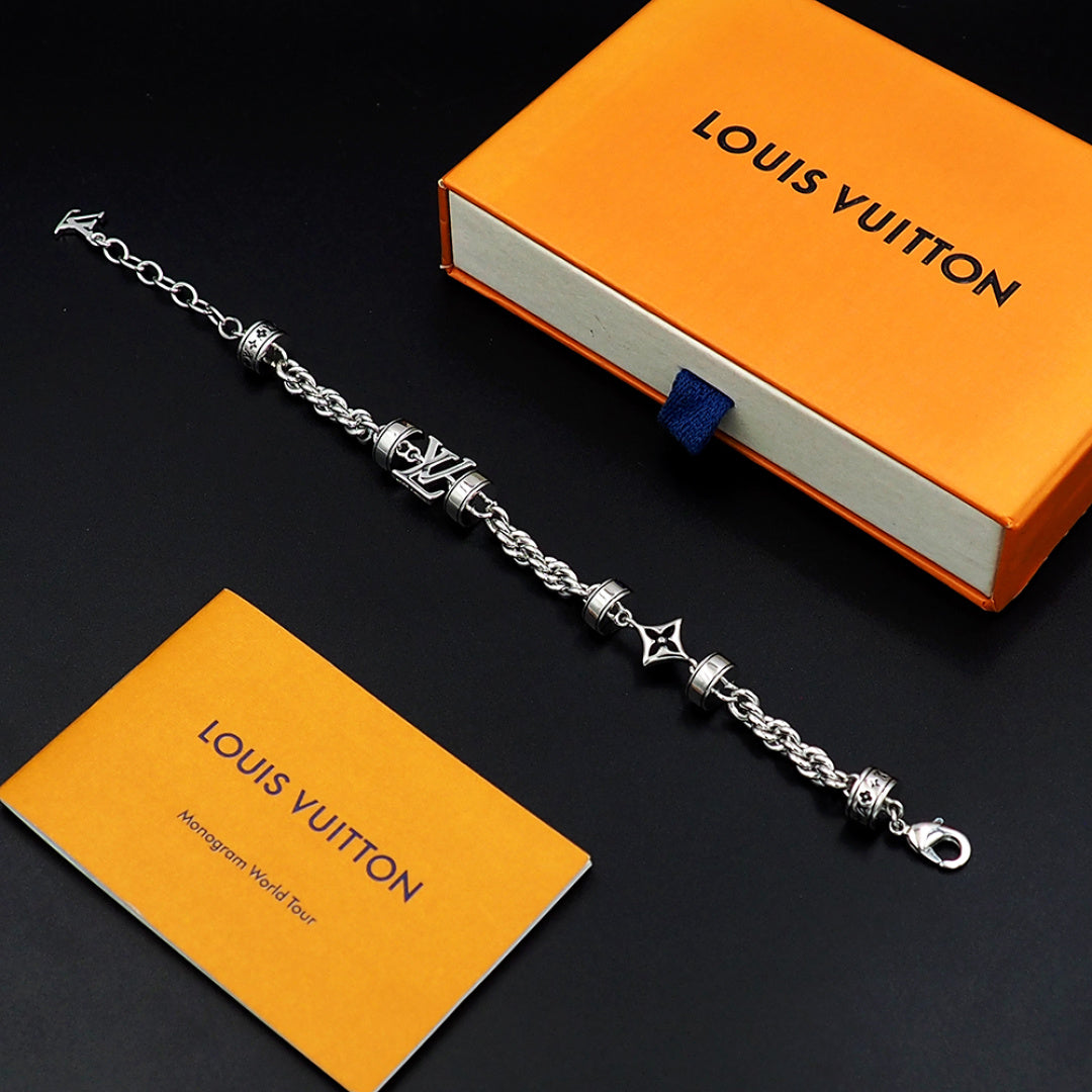 Silver chain bracelet with logo charms and star accents