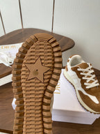 Sneaker outsole with star tread detail, paired brown-and-white shoes on shoebox