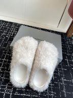White faux-fur slide sandals, showing the open toe and rounded front