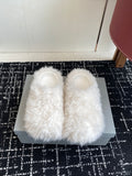 White faux-fur slip-on sandals with open toe and wide, fluffy upper