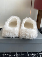 Pair of white faux-fur slip-on sandals with open toe and rounded front