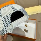 Louis Vuitton baseball cap with adjustable strap, white-black dot print and black V