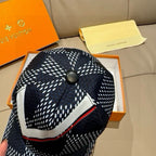Louis Vuitton baseball cap, front close-up with black crown, white print, red accent