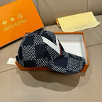 Louis Vuitton baseball cap, angled view with black-white pattern and red-edged strap