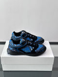 Blue and black sneakers with black laces and textured panels on the upper