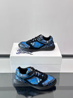 Blue and black sneakers on a shoebox, side view with sculpted sole