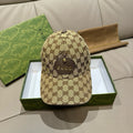 Gucci GG monogram baseball cap in beige with dark logo pattern and gold emblem detail.