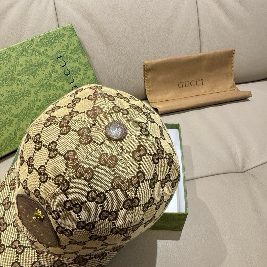 Gucci GG monogram baseball cap top with round gold button on beige patterned crown.