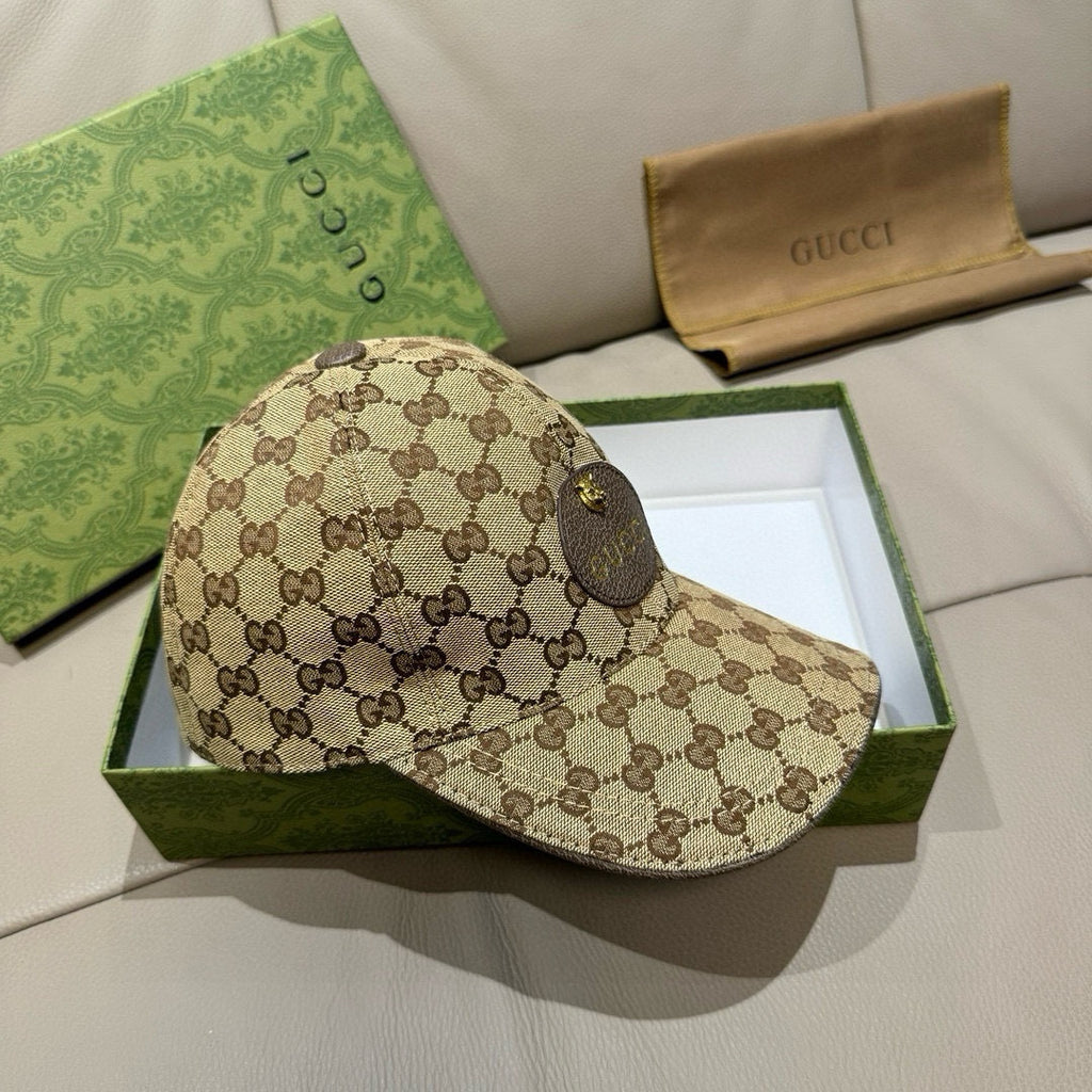 Gucci GG monogram baseball cap in beige, side profile with dark logo pattern and gold detail.