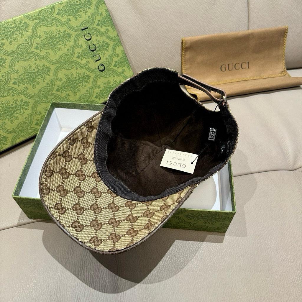 Gucci two-tone cap with GG monogram brim, black crown interior, and adjustable strap hardware.