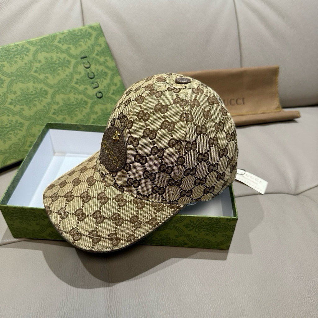 Gucci GG monogram baseball cap, beige cap with dark allover logo pattern and curved brim.