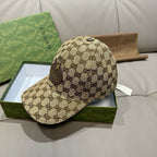Gucci GG monogram baseball cap, beige cap with dark allover logo pattern and curved brim.