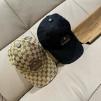 Gucci caps set: one beige GG monogram cap and one black cap with Gucci logo badge.