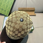 Gucci cap top view with beige GG canvas crown and black textured brim