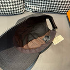 Louis Vuitton baseball cap in dark black with open interior showing lining and tag.