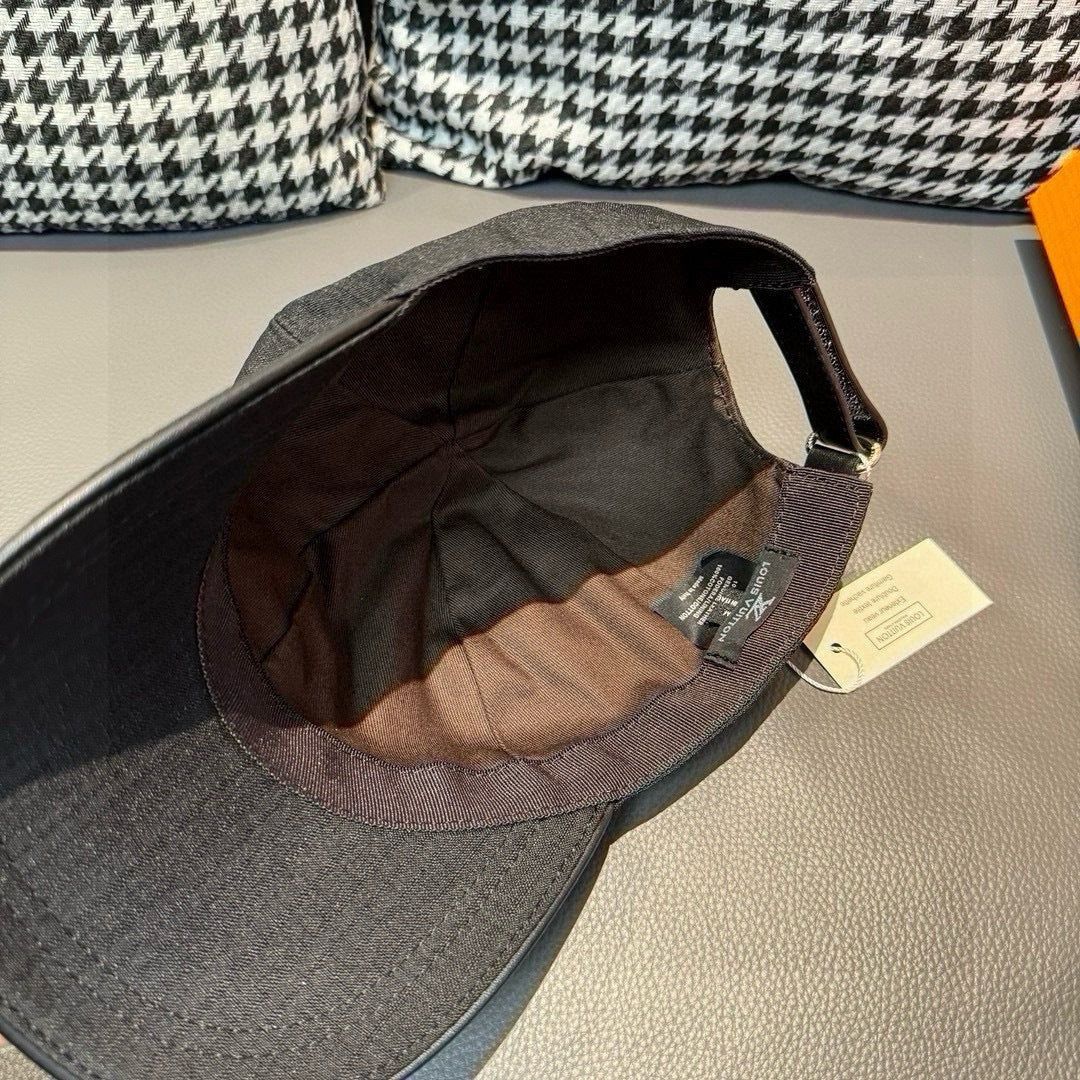 Louis Vuitton baseball cap in dark black with open interior showing lining and tag.
