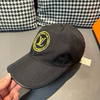 Louis Vuitton baseball cap in dark black with embroidered yellow LV logo patch.