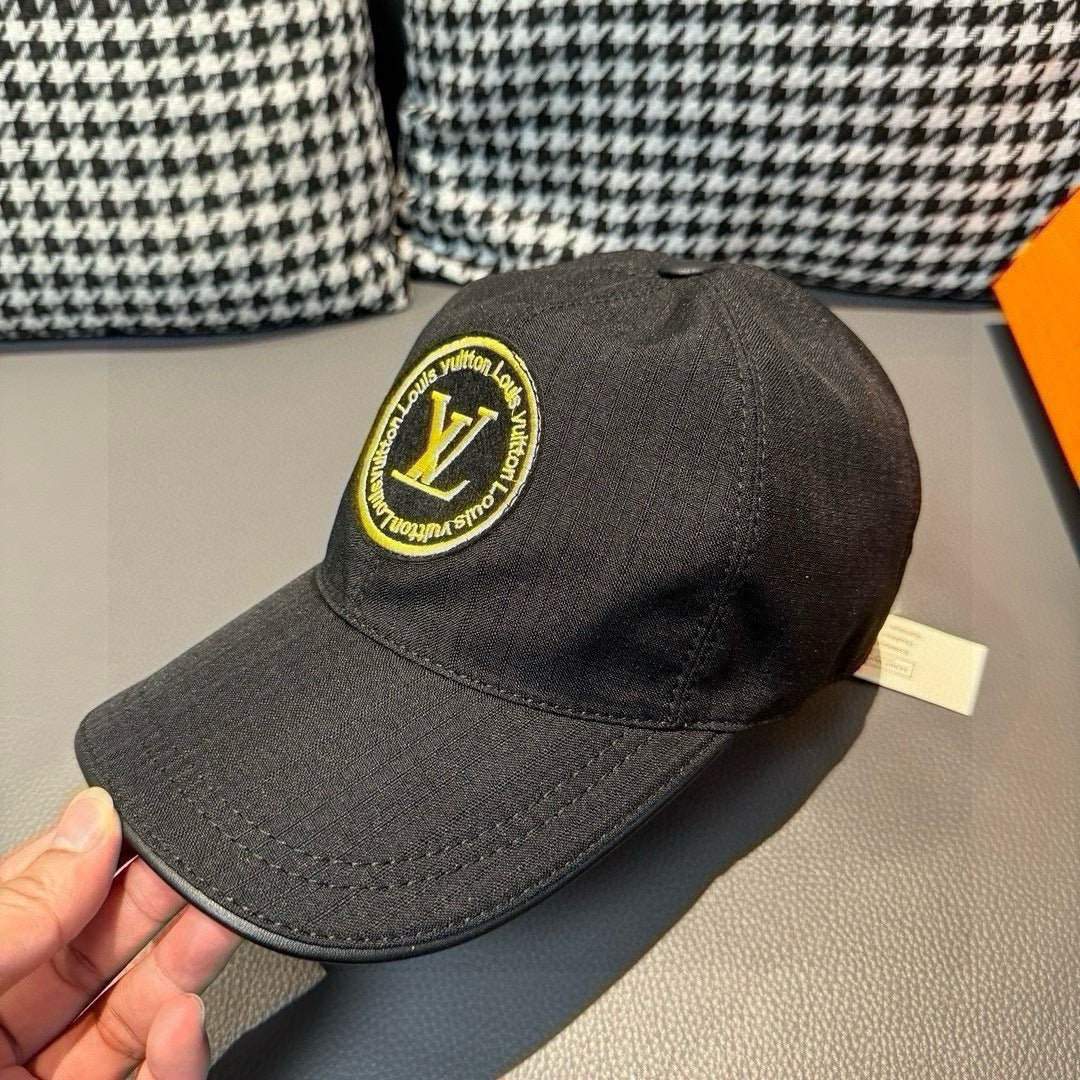 Louis Vuitton baseball cap in dark black with embroidered yellow LV logo patch.