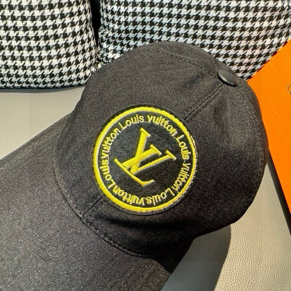 Louis Vuitton baseball cap back view in dark black with large yellow LV logo patch.
