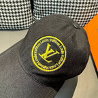 Louis Vuitton baseball cap back view in dark black with large yellow LV logo patch.