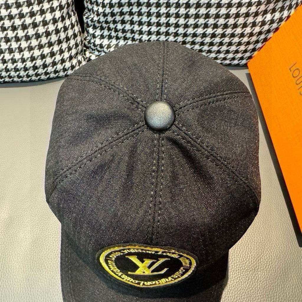 Louis Vuitton baseball cap back view in dark black with button top and yellow LV logo.