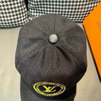 Louis Vuitton baseball cap back view in dark black with button top and yellow LV logo.
