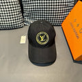 Louis Vuitton baseball cap in dark black with yellow LV circular logo patch.