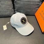 Louis Vuitton white baseball cap with front LV logo patch and side stitching
