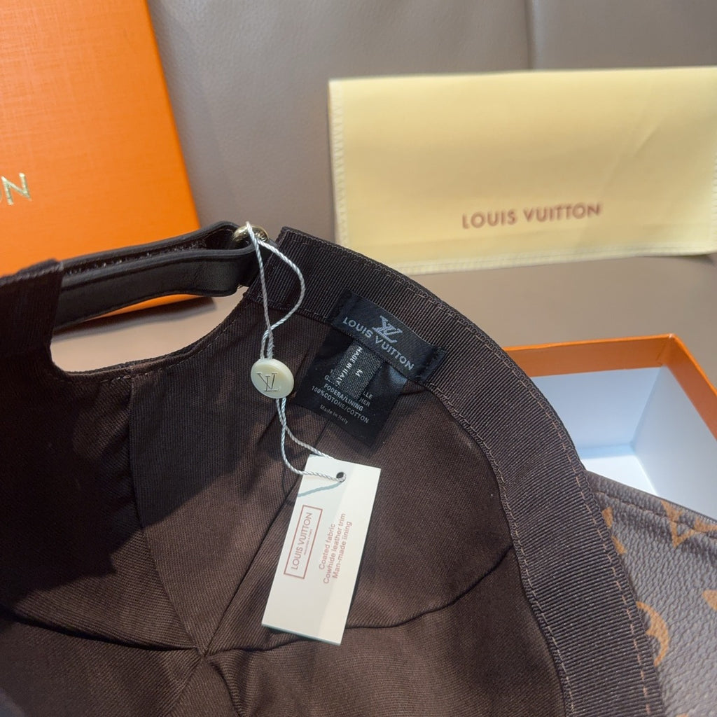 Louis Vuitton cap close-up of inside panel with neck strap and hanging tags.