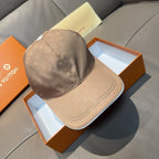 Beige monogram baseball cap with curved brim and stitched crown paneling
