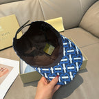 Burberry logo cap with blue and white monogram pattern, dark interior view