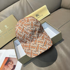 Patterned baseball cap with tan, rust and black logo print, curved brim