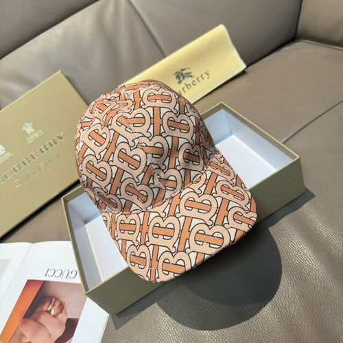 Patterned baseball cap with tan, rust and black logo print, curved brim