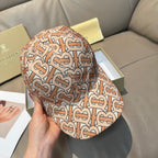 Patterned baseball cap with tan, rust and black logo print, close side view