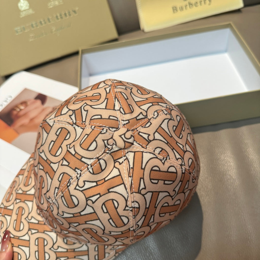 Patterned baseball cap with tan, rust and black logo print, angled close-up