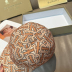 Patterned baseball cap with tan, rust and black logo print, angled close-up