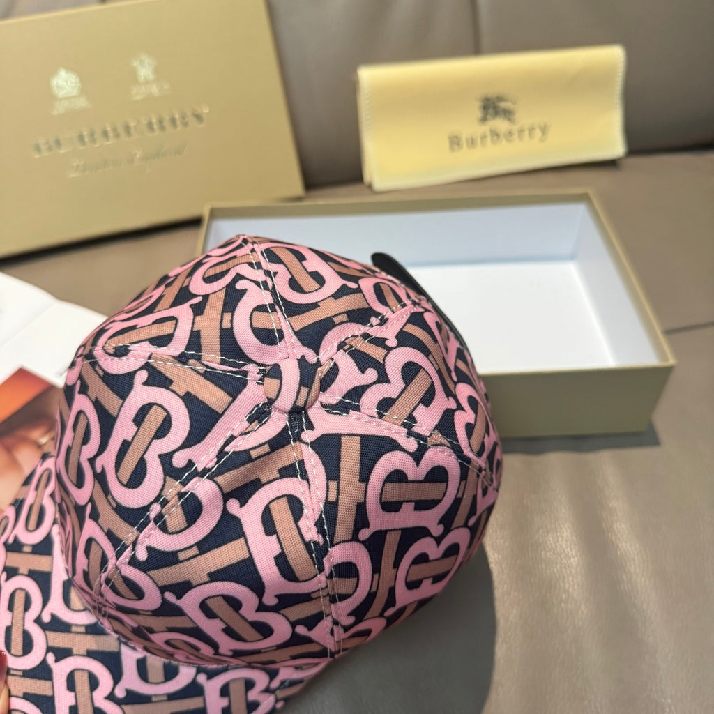 Burberry cap with pink and black monogram pattern, close-up of curved brim