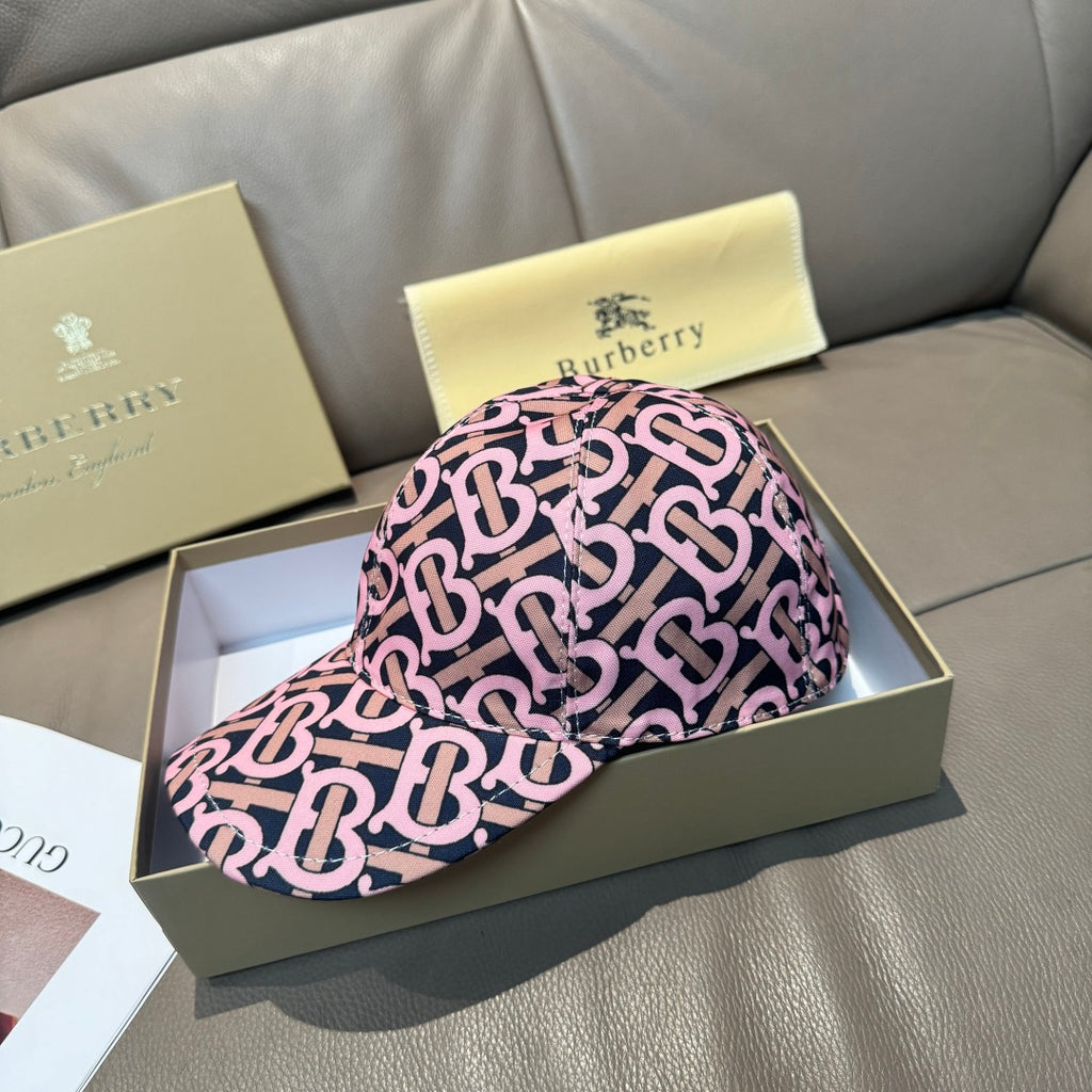 Burberry cap with pink and black monogram pattern, curved brim and side profile view
